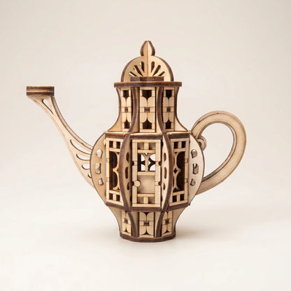 Wooden teapot fairy house laser cut model shown on a clean light background, featuring detailed windows, door, handle, spout, and decorative layered design.