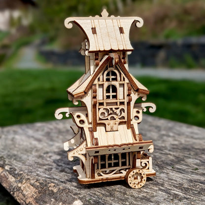 Fantasy camper van puzzle of laser cut plywood beautifully capturing bright morning sunbeams on a grey stone block.