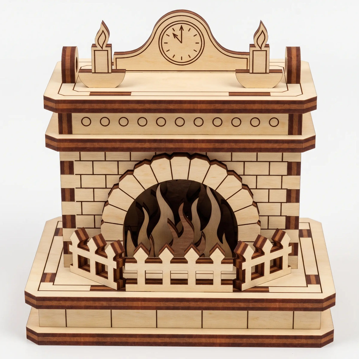 Front view of natural laser cut plywood fireplace model with mantel clock, carved candles, and flame cutout on white base.