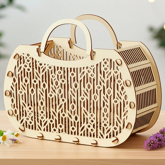 Laser cut plywood wooden handbag-shaped floral basket with intricate organic pattern on the front and slatted sides, sitting on a light wood surface with real flowers and blurred bokeh background.