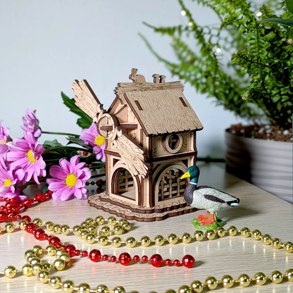 Left perspective view of the miniature wood windmill with detailed engraving, made from layered laser cut plywood sheets.
