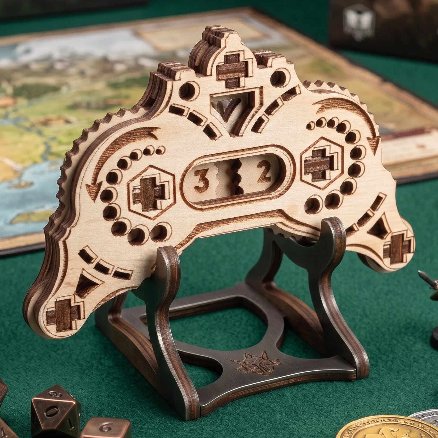 Wooden laser cut gamepad counter with decorative design on a green surface
