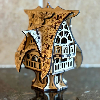 An elegant side angle shot of a whimsical miniature fairytale house model of laser cut plywood on a glossy polished table