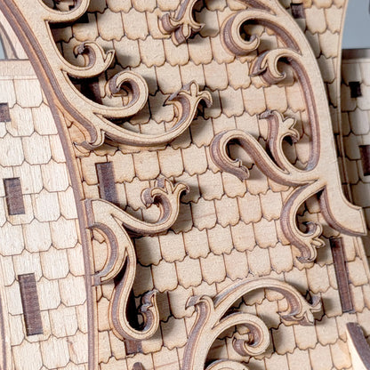 Macro texture shot of an intricate shingle roof with swirling filigree carved from natural laser cut plywood layers.