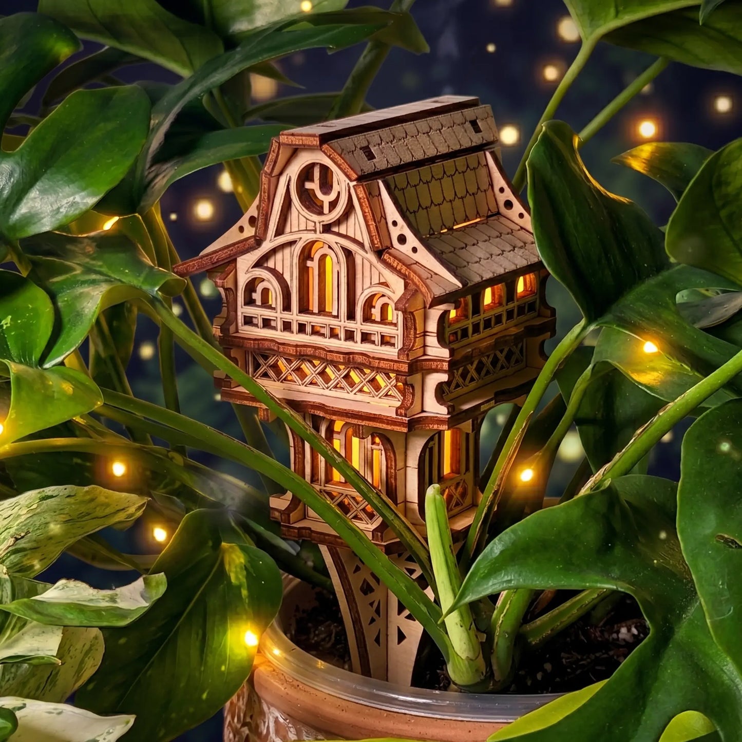 Garden plant house laser cut model with glowing lights surrounded by green plants