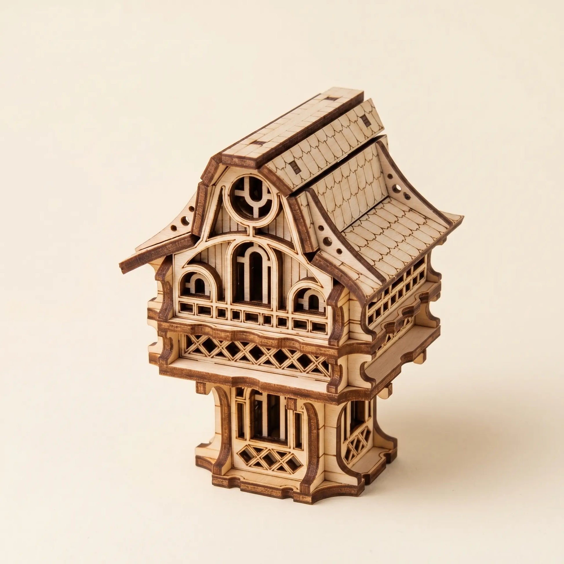 Wooden model of a fairy-like structure on a beige background