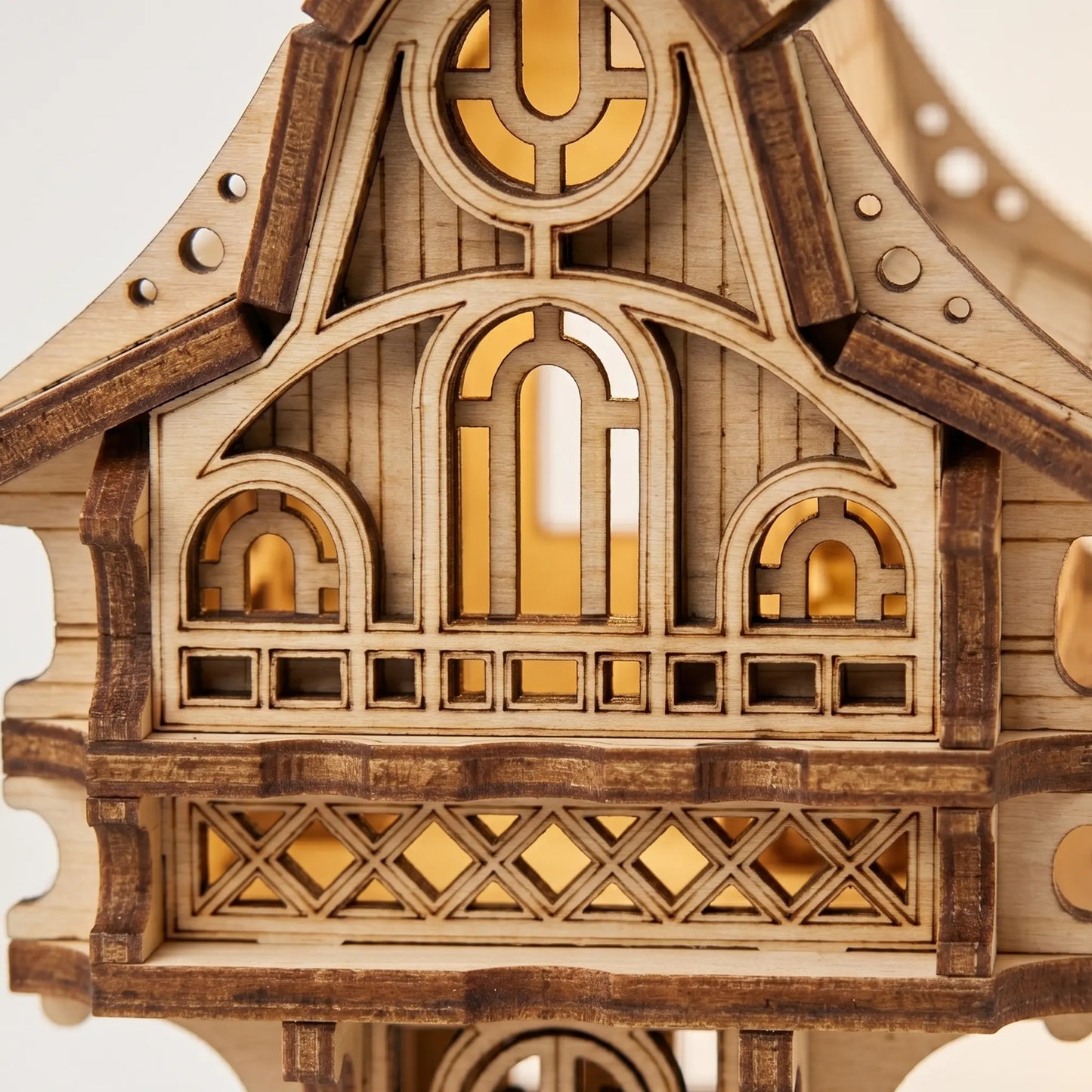 Wooden architectural model with intricate design on a white background