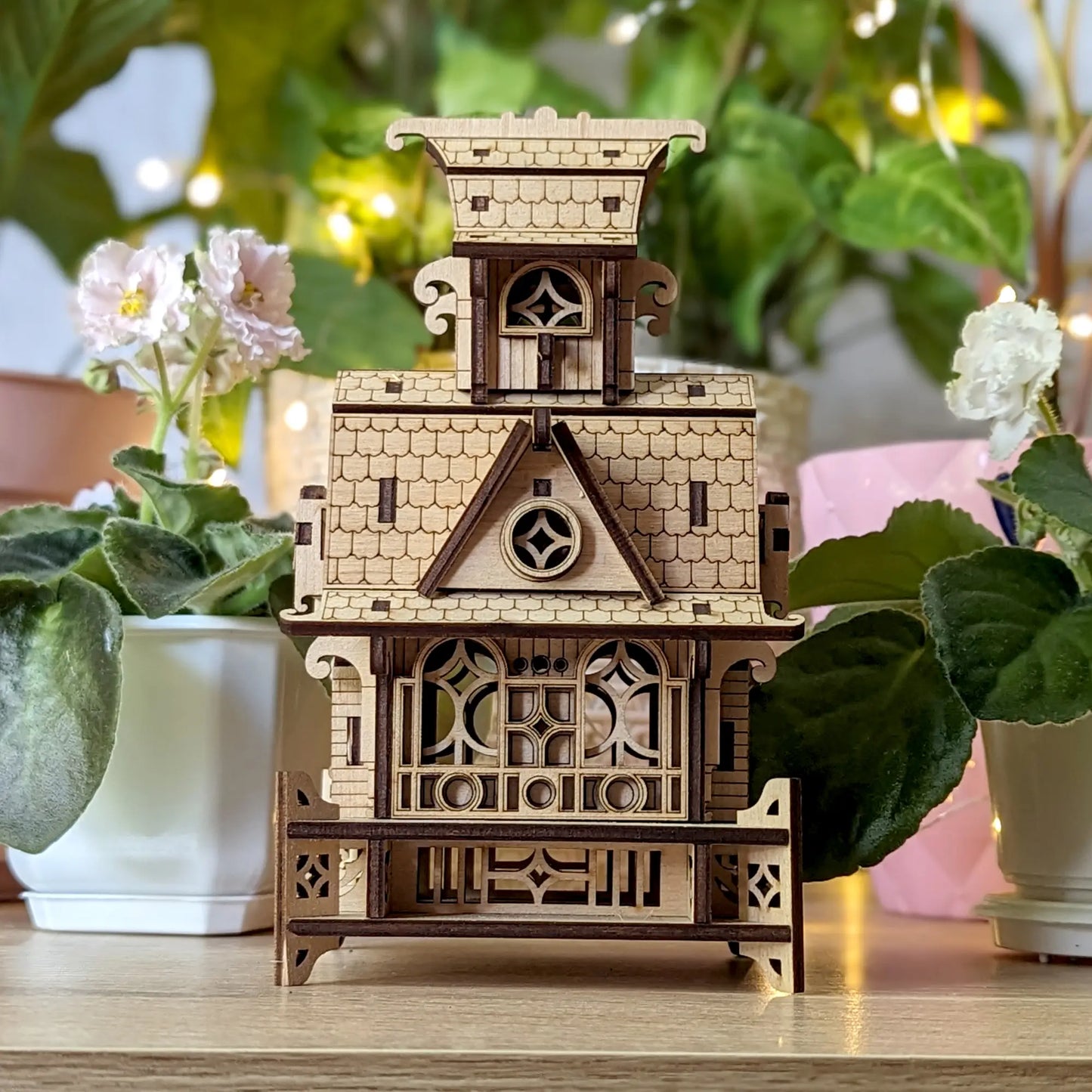 Precise architectural front view of a miniature fairy house model kit, built from layered laser cut plywood.