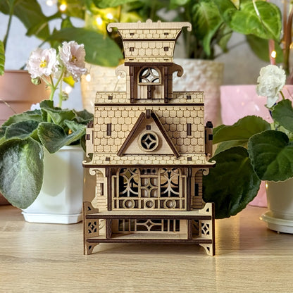 Straight front studio portrait of the assembled ornamental fairy home project, made from laser cut plywood boards.