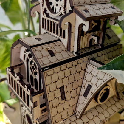 Macro macro shot highlighting the engraved roof shingles and curved accents of a laser cut plywood fairy house.