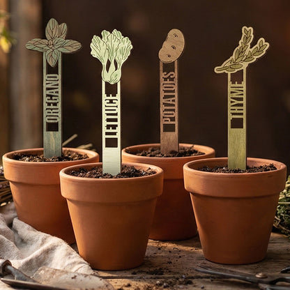 Wooden laser cut Garden Stakes 2 set showing oregano, lettuce, potatoes, and thyme with detailed plant shapes and engraved names, placed in soil pots against a warm indoor gardening background.