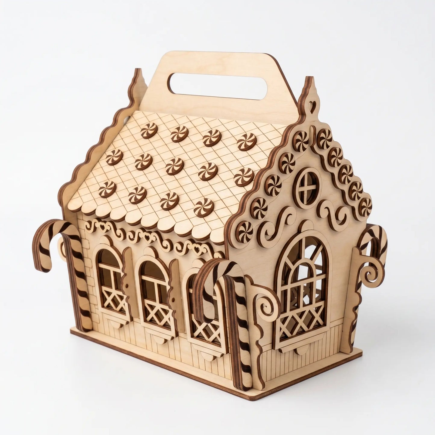 Wooden house-shaped box with intricate designs on a white background