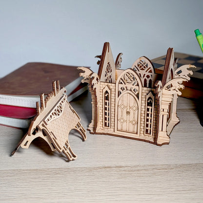 A product photo of an assembled gothic crypt box with its roof detached on a table, crafted from fine laser cut plywood.