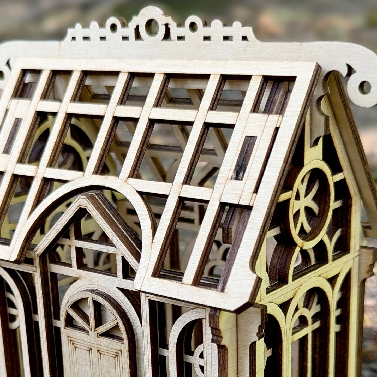 A lovely angled perspective view of an assembled miniature greenhouse puzzle model crafted out of fine laser cut plywood.