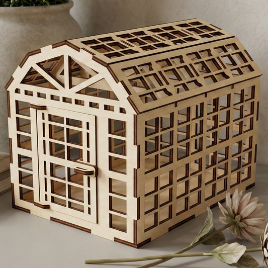 Elegant laser cut wooden greenhouse with classic barn-style roof, open sides, and precise beam details, presented against a warm neutral indoor background.