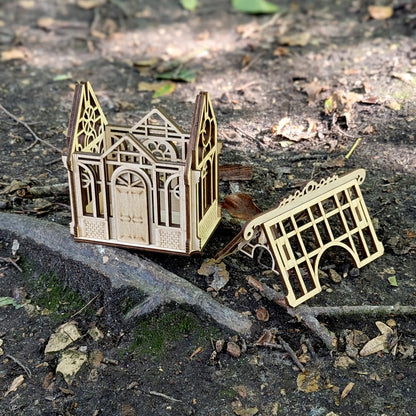 A straight side profile view highlighting the clean interlocking joints of a mini greenhouse built of laser cut plywood.