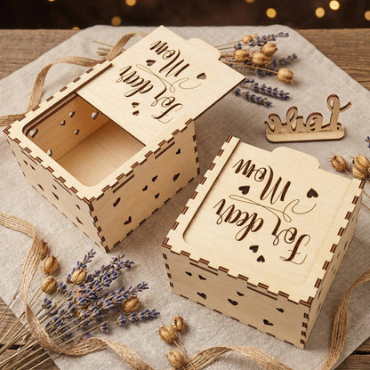 An angled top view of two "For dear Mom" laser-cut wooden boxes—one open and one closed. The high-quality plywood construction shows dark burnt edges and heart-shaped side details. Arranged with rustic twine and dried lavender, perfect for Mother’s Day or a personalized birthday gift presentation.
