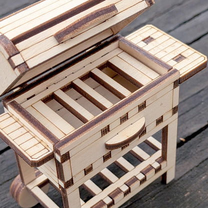Close-up view of the laser cut wooden BBQ grill top, showing the open lid and slatted grill area with detailed wood joinery.
