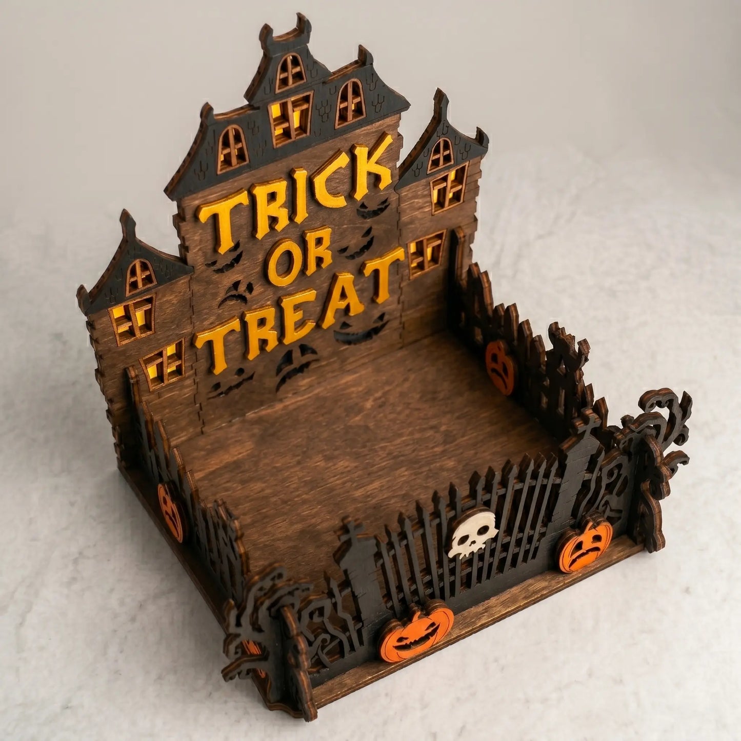 Halloween-themed wooden house with 'Trick or Treat' text on a light gray background
