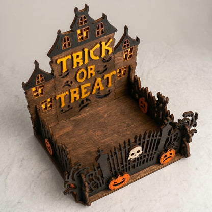 Halloween-themed wooden house with 'Trick or Treat' text on a light gray background