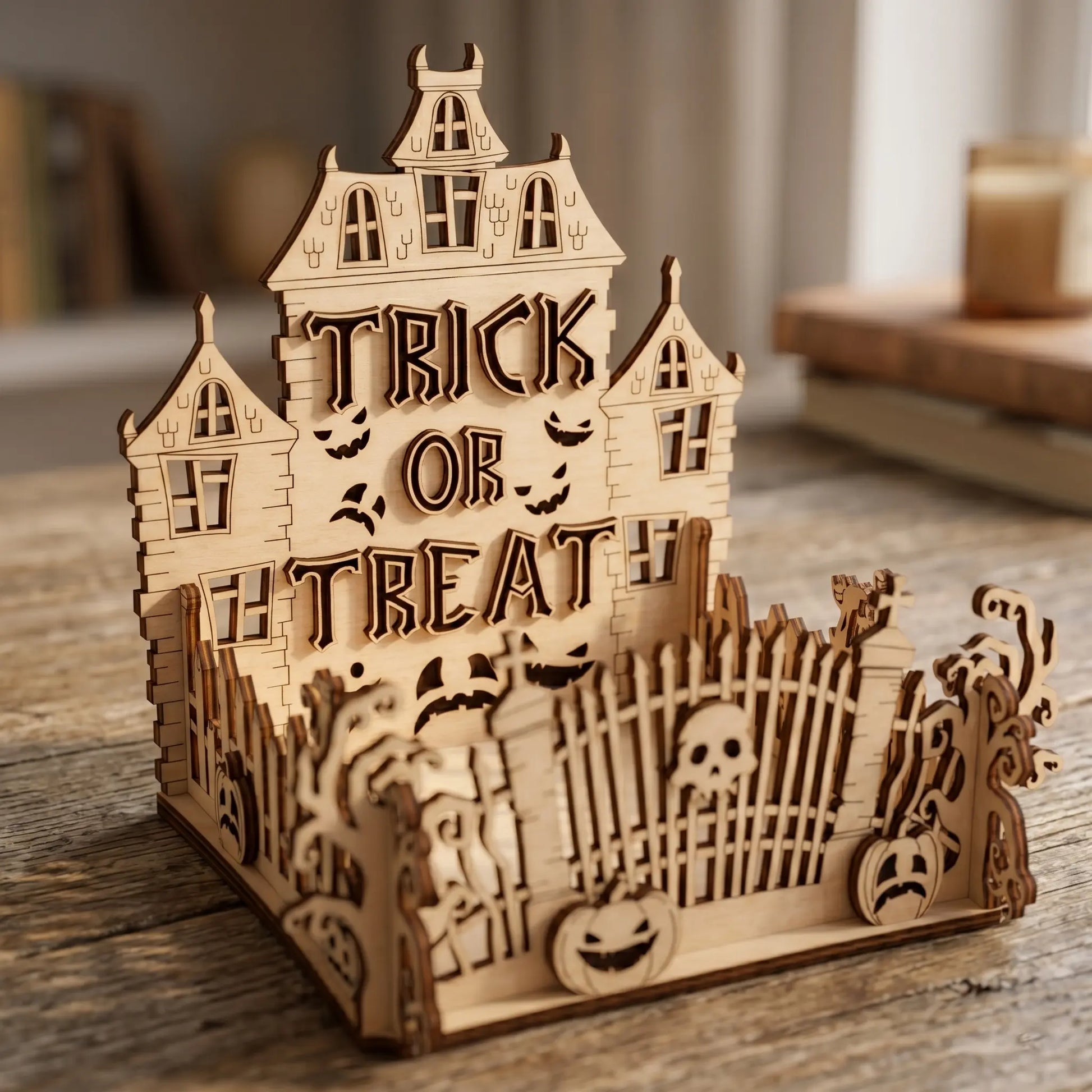 Wooden Halloween-themed house with 'Trick or Treat' text on a wooden surface.