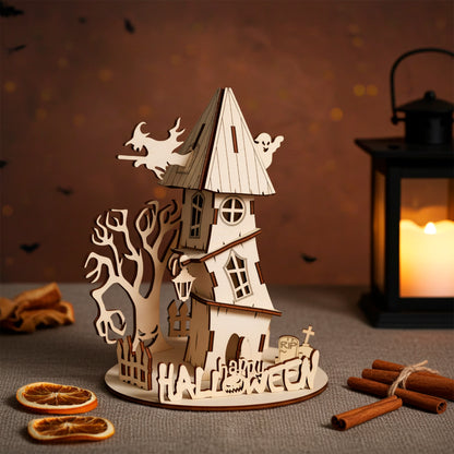 Laser cut plywood wooden haunted house decoration with a witch, ghost, spooky tree, and "Halloween" fence, set on a dark shelf with pumpkins, cotton web, and a candle lantern creating an eerie glow
