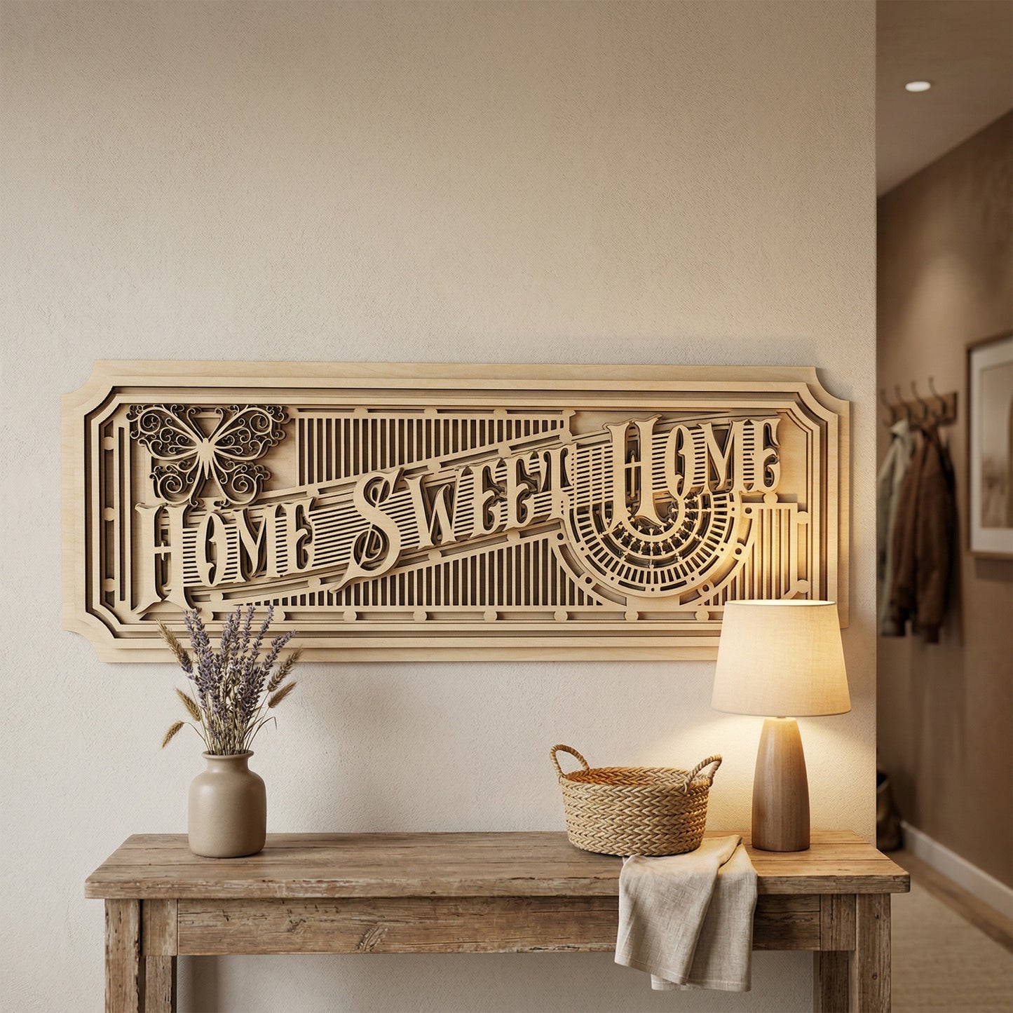 A large, multi-layered 3D "Home Sweet Home" sign handcrafted from laser-cut plywood. The intricate design features an Art Deco aesthetic with geometric lattices, a decorative butterfly icon, and stacked wood panels. Displayed on a neutral wall above a rustic entryway table with a warm lamp and lavender.