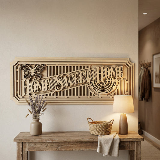 A large, multi-layered 3D "Home Sweet Home" sign handcrafted from laser-cut plywood. The intricate design features an Art Deco aesthetic with geometric lattices, a decorative butterfly icon, and stacked wood panels. Displayed on a neutral wall above a rustic entryway table with a warm lamp and lavender.