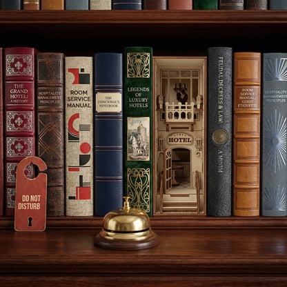 Detailed Hotel Book Nook made of laser cut wood, displayed with a gold service bell in a cozy bookshelf background.