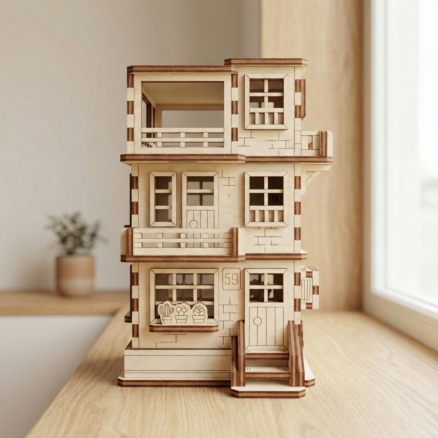 Wooden laser cut dollhouse model on a wooden surface with a neutral background