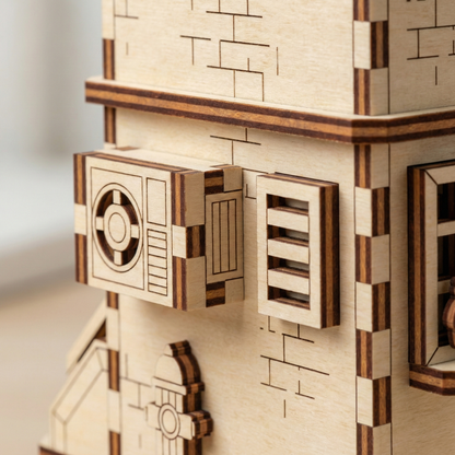 Close-up of a wooden laser cut model kit with intricate cut-out designs on a neutral background