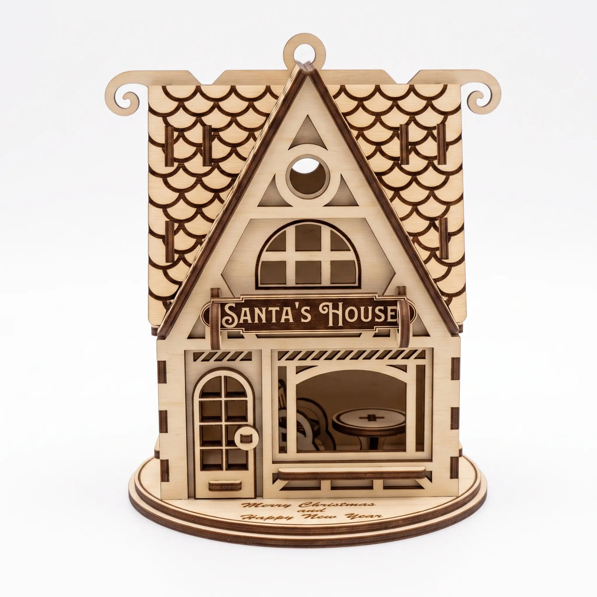 Straight front view of laser cut plywood Santa's House lantern on white background showing front door.