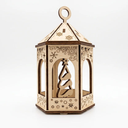 Assembled laser cut plywood lantern ornament with cutout Christmas tree inside isolated on white