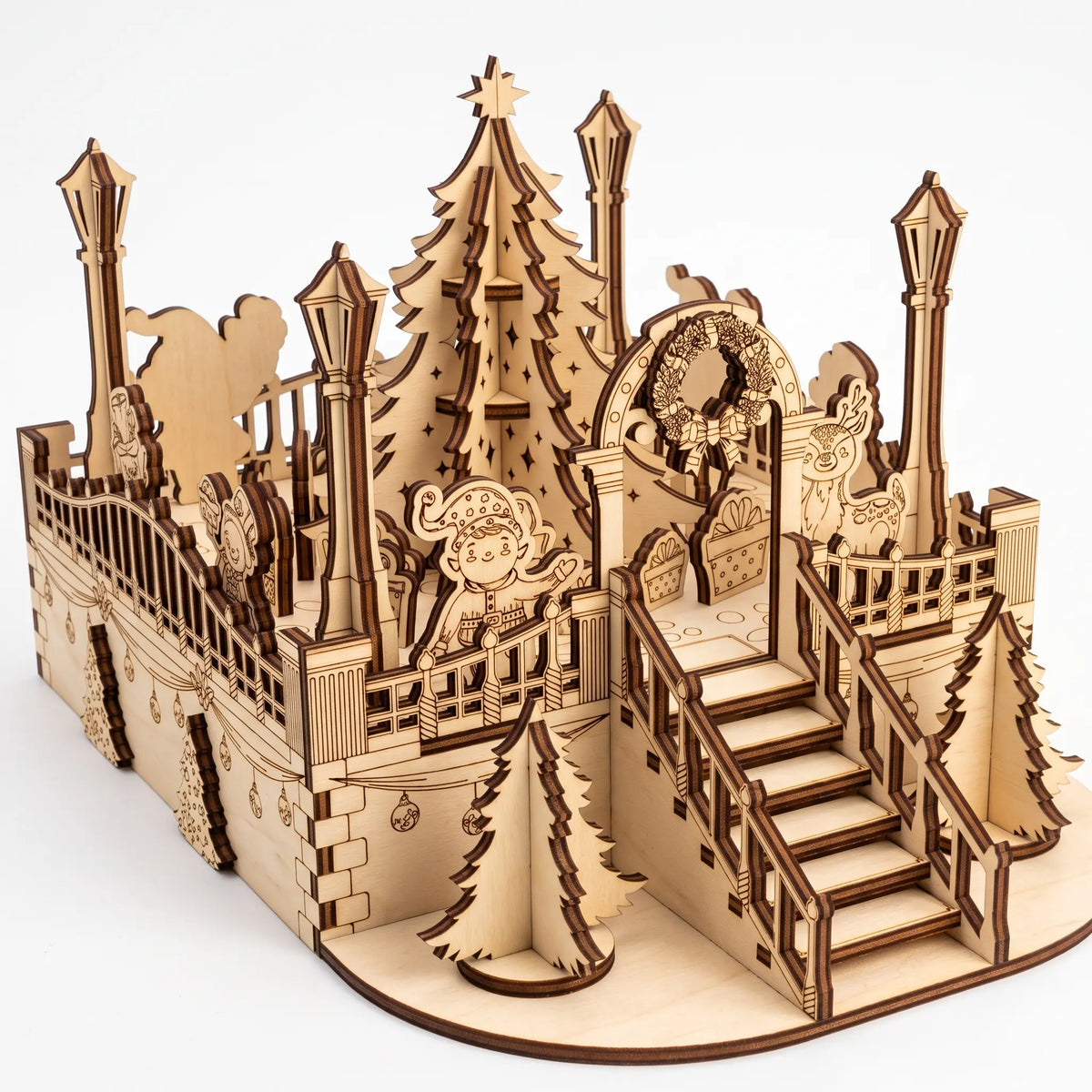 Elevated three-quarter view of laser cut plywood holiday plaza kit with staircase, lanterns, and festive figures.