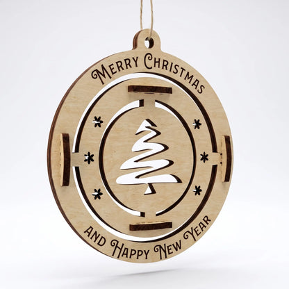 Front view of laser cut plywood bauble with fir tree cutout and engraved holiday greetings on plain white.