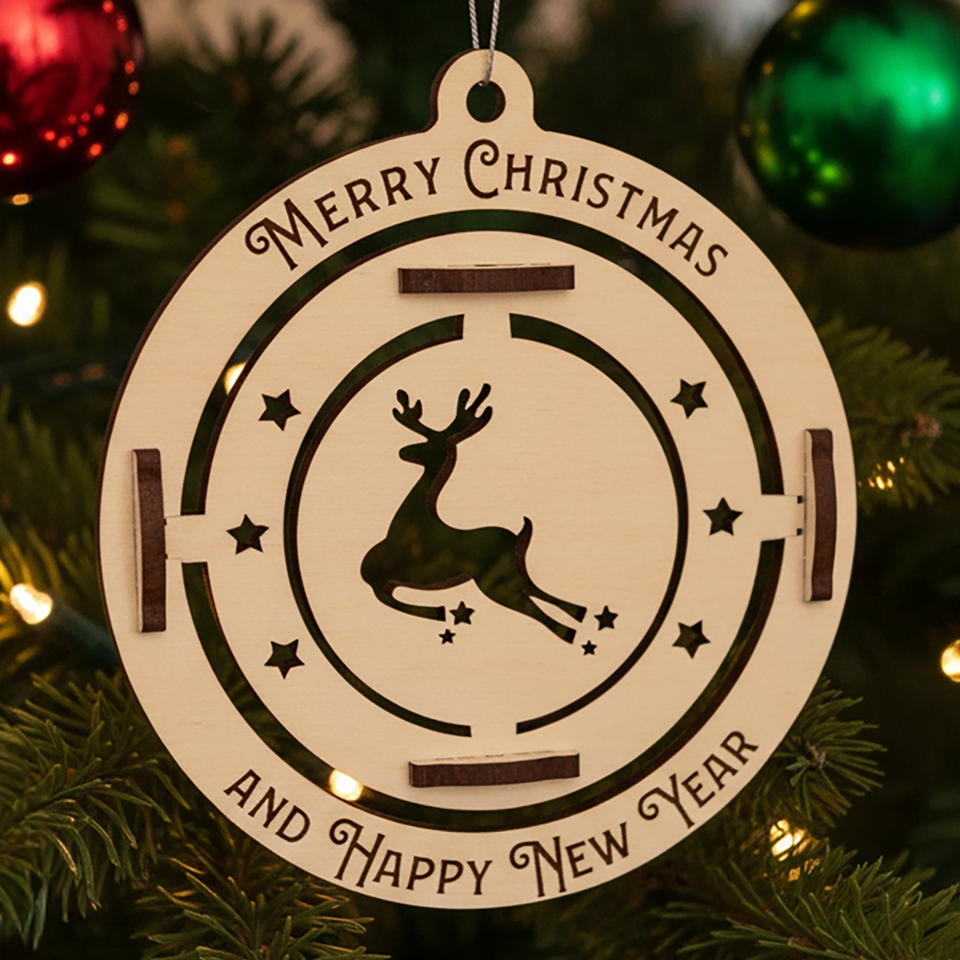 Laser cut wooden Christmas tree toy deer featuring a spinning reindeer silhouette inside a round frame with "Merry Christmas and Happy New Year" engraving, displayed against a festive lighted Christmas tree background.