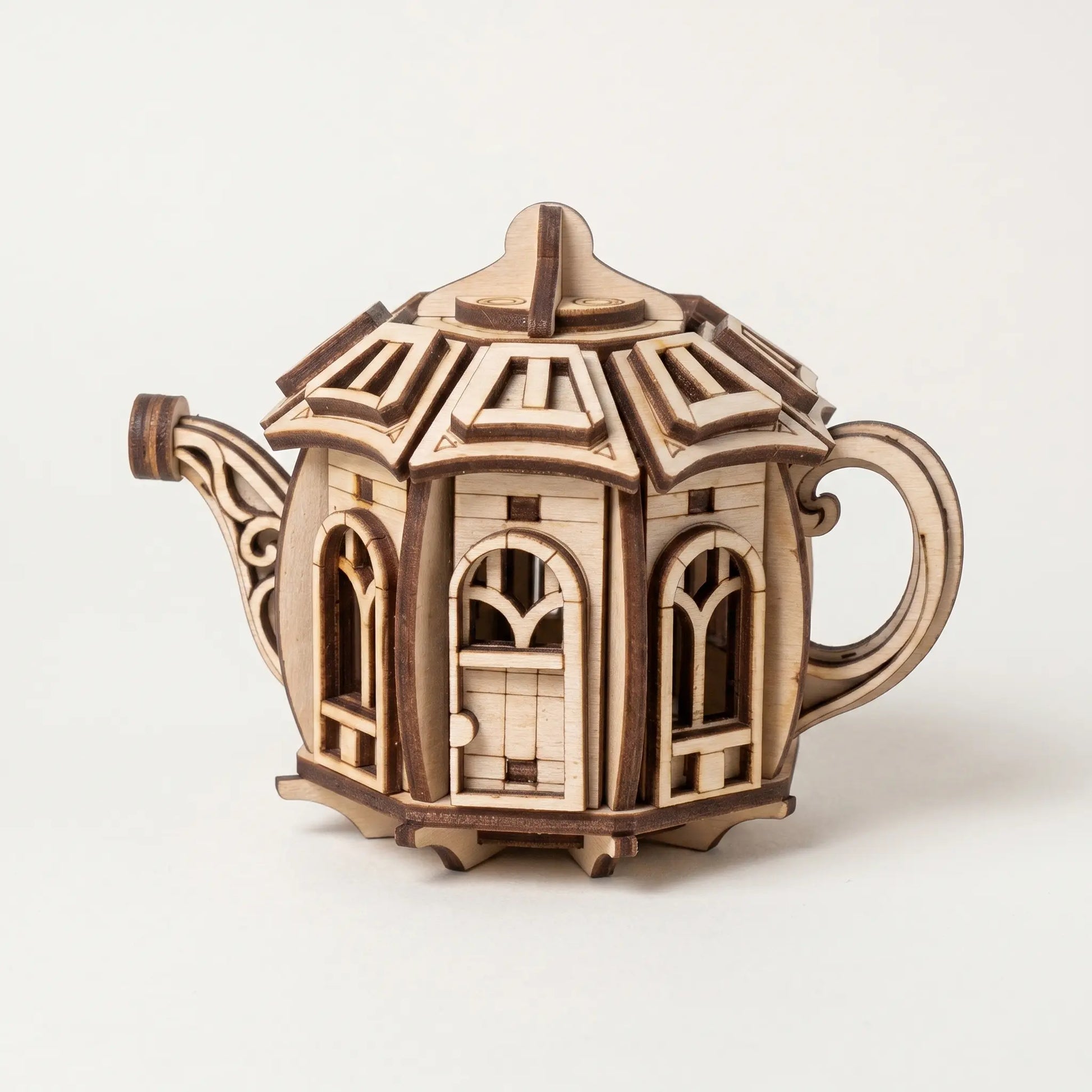 Wooden kettle laser cut model with intricate design on a white background