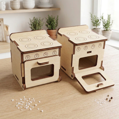 Detailed view of dollhouse kitchen cabinets and stove crafted from smooth laser cut plywood. The units feature engraved burner details, tiny circular knobs, and functional-looking doors, showing the clean wood grain and precise assembly of the furniture.