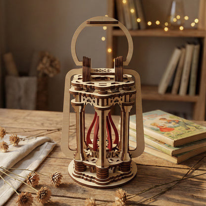 Elegant laser cut wooden Lantern with tall arched handle, multi-layered column design, and flowing red ribbons inside, presented against a blurred cozy room background with string lights.