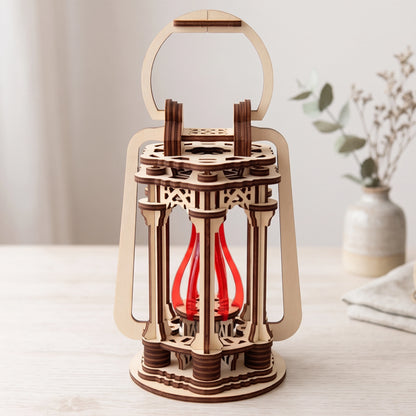 Vintage laser cut plywood lantern candle holder with red inner acrylic flame core standing on bright wooden tabletop