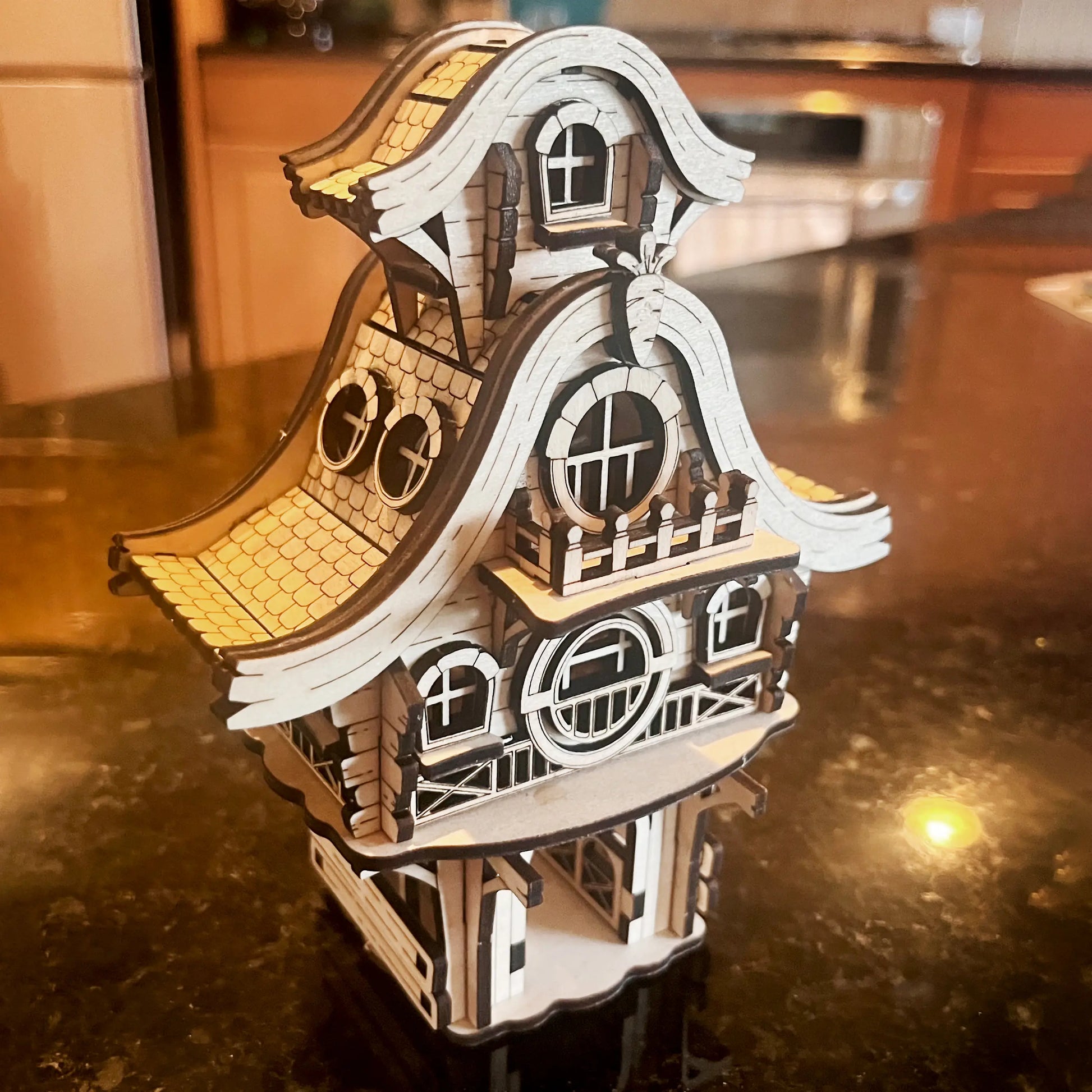 Cute easter bunny house miniature made of laser cut plywood, beautifully resting among bright yellow blooming spring bush.