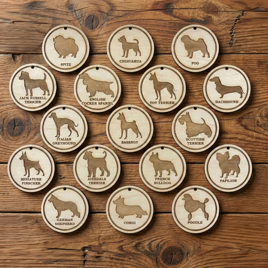 Set of laser cut wooden dog breed ornaments on a wooden surface