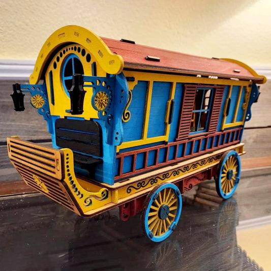 A colorful wooden Nomad Wagon 3d puzzle laser cut model, assembled and displayed on a flat surface.