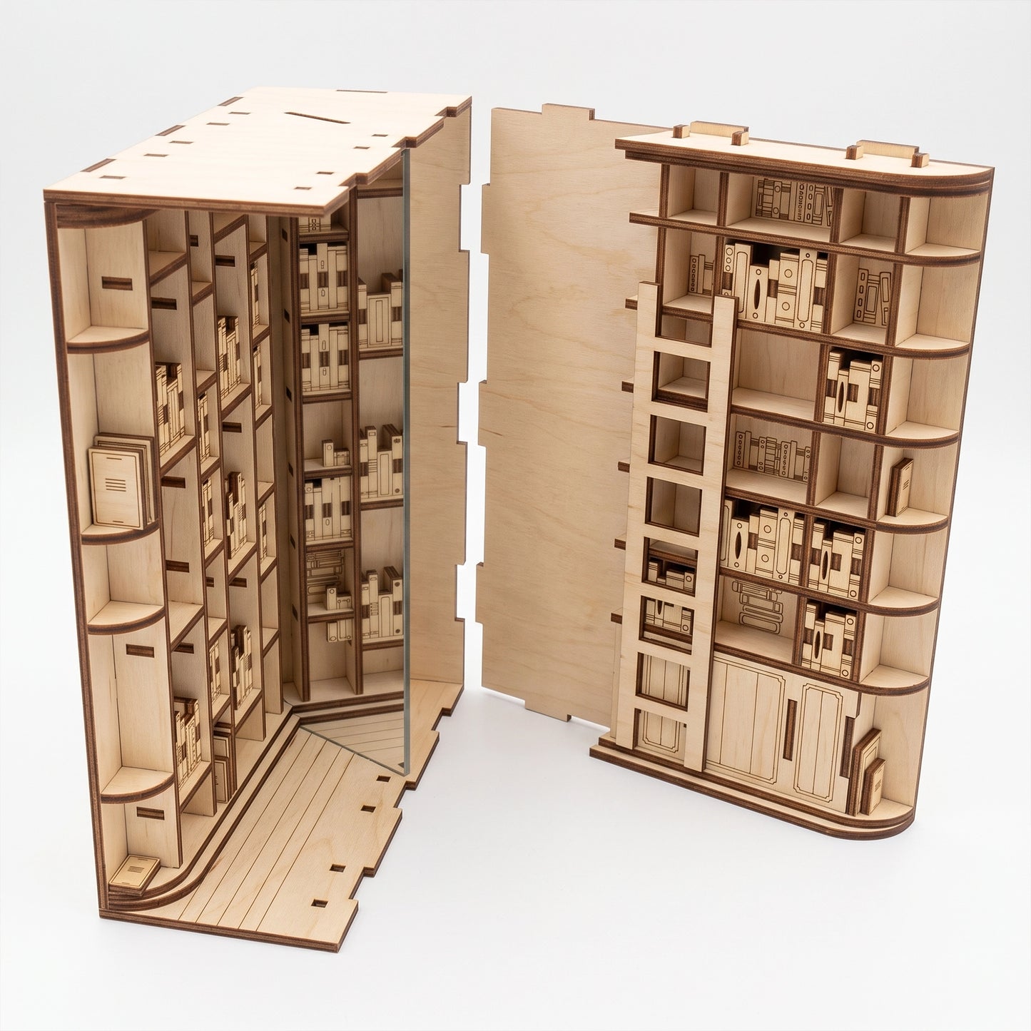 Exploded view of a laser-cut birch plywood library book nook, showing detailed miniature shelves and natural wood grain.