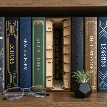 A laser cut Library Book Nook diorama featuring curved internal shelving, displayed between hardcover books with a home study background.