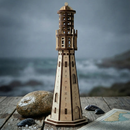 Miniature runic laser cut plywood lighthouse staged outdoors on a weathered pier with a stormy sea background.