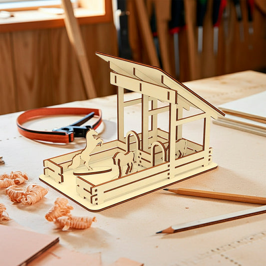 Laser cut  plywood wooden miniature horse stable with two stalls and horse silhouettes, placed on a light workbench surrounded by wood shavings, pencils, and crafting tools in a sunny workshop
