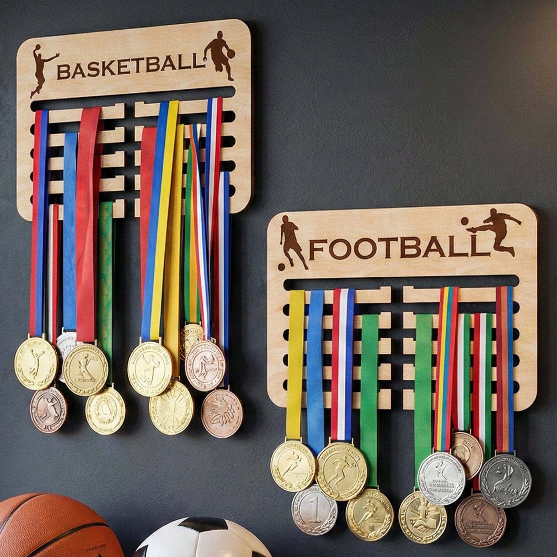 Laser cut wooden medal holders for basketball and football mounted on a wall in a sports-themed room background.