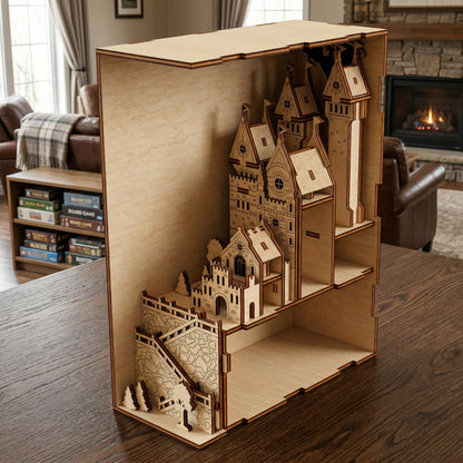 An opened laser cut wooden Medieval Castle Book Nook revealing a multi-tiered fortress design with pointed towers, sitting on a wooden table with a cozy living room background.