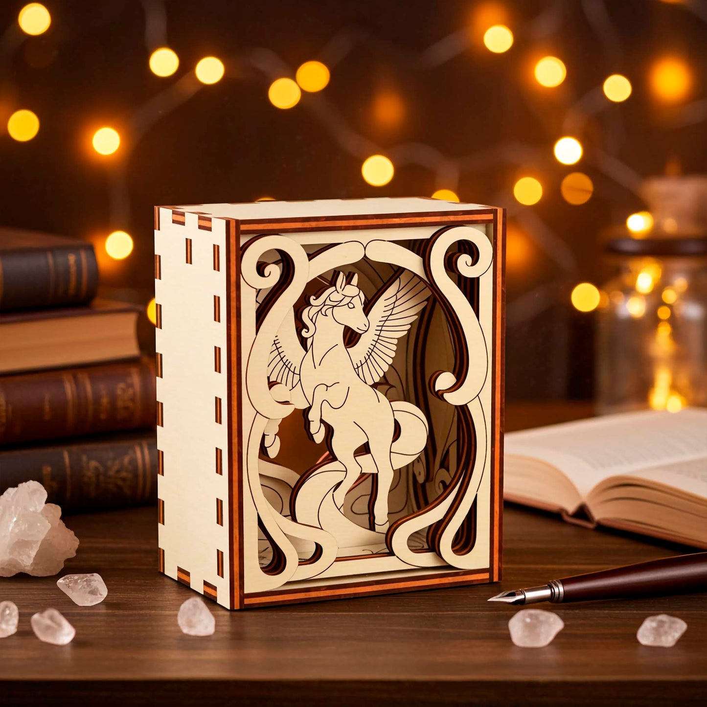 Wooden box with pegasus laser cut design on a wooden surface with books and crystals.